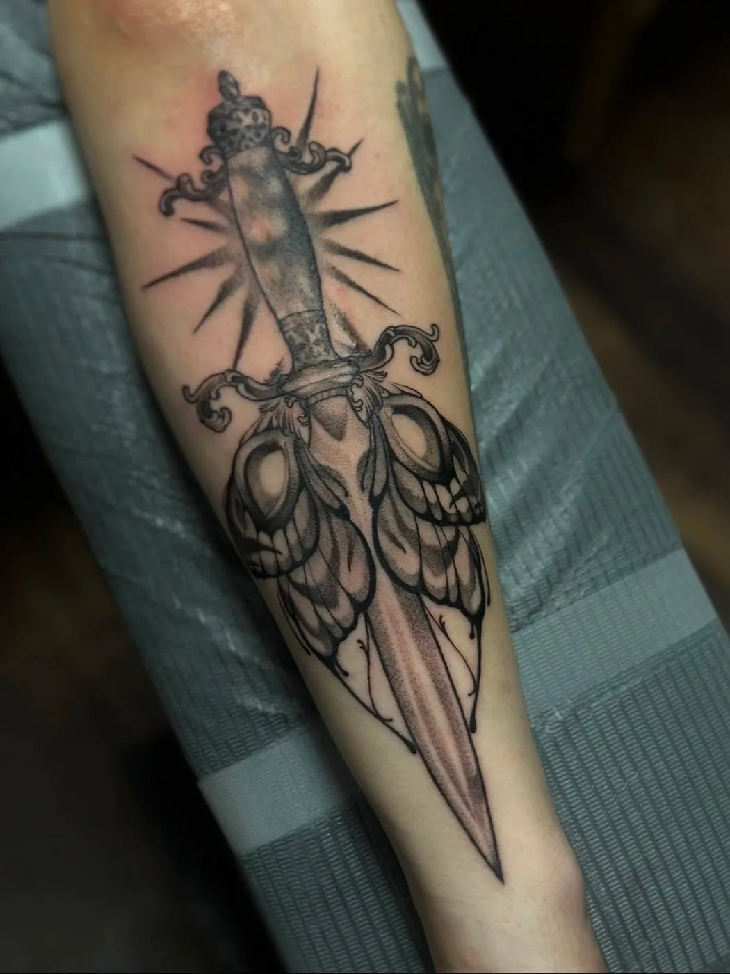 Moth dagger with sunburst by Preston, Alliance Tattoo Eugene Oregon